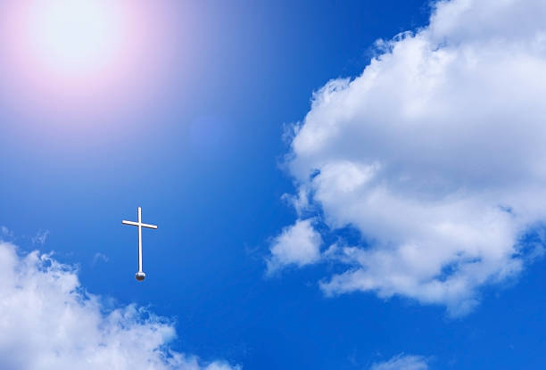 The Christian cross appears against the sky