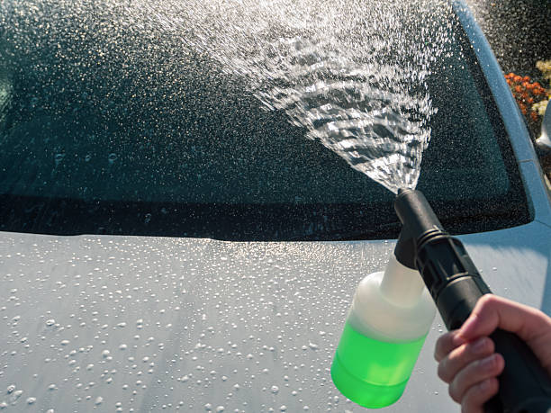 Manual car high-pressure wash using equipment for effective dirt removal and coating protection.