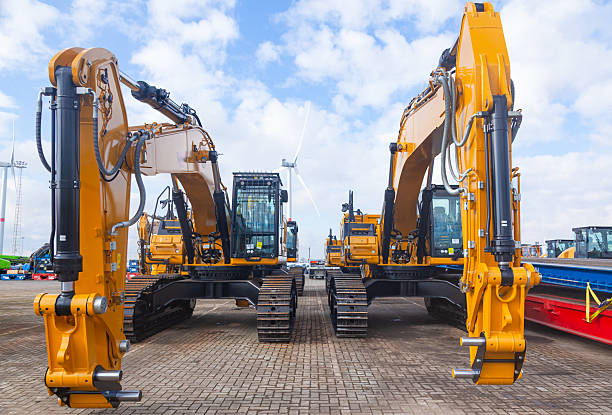 istock New yellow crawler excavators are parked on the site. 2208531804