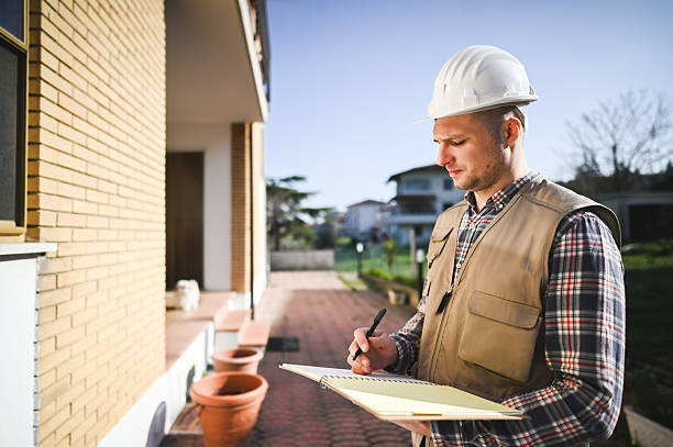 istock Building inspector taking notes during an inspection of a house 2208533088