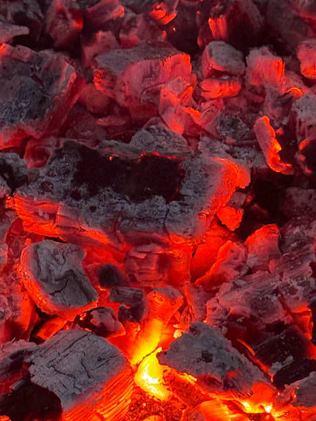 istock The Radiant Glowing Charcoal Embers Illuminated at Night, Creating a Vibrant Atmosphere 2208533480