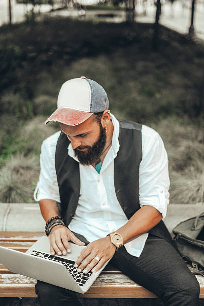 istock Bearded Man Working on Laptop in Outdoor Setting 2208534863