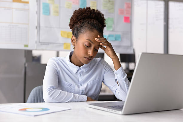 istock Frustrated tired African project manager touching head with closed eyes 2208535782