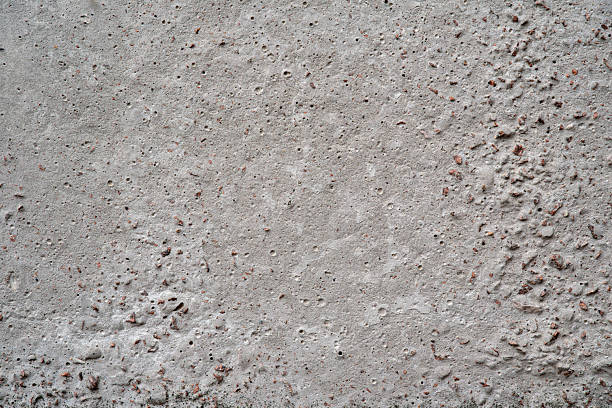 Gray concrete surface with small holes and irregularities