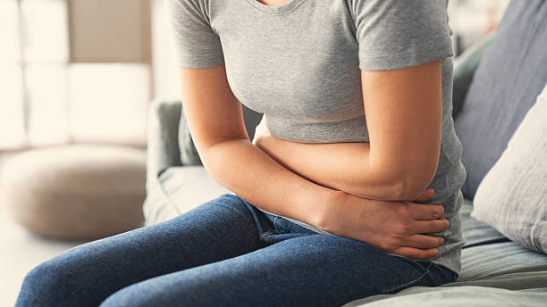 istock Young woman with stomach ache 2208537412