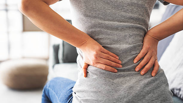 istock Woman with back pain in home 2208538114
