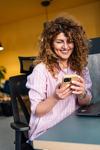 istock Woman using phone in the office 2208538283