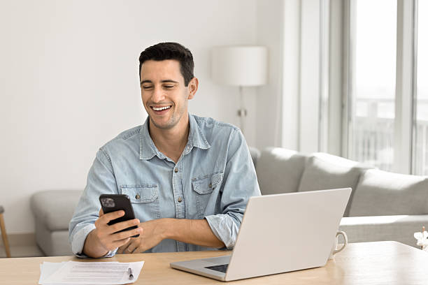 istock Happy successful Latin freelance businessman using digital gadgets 2208539676