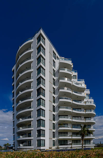 istock Modern architecture stands tall against a vibrant blue sky showcasing elegant curves and balconies in a coastal setting 2208540050