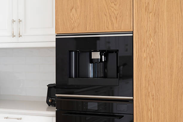 istock Built-in coffee machine installed in a wooden kitchen cabinet 2208541134