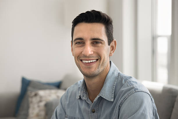 istock Happy handsome young Hispanic man looking at camera 2208543138