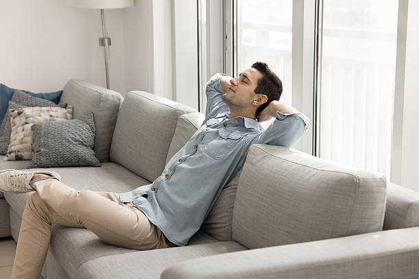 istock Calm handsome Latin man relaxing on comfortable couch 2208544741