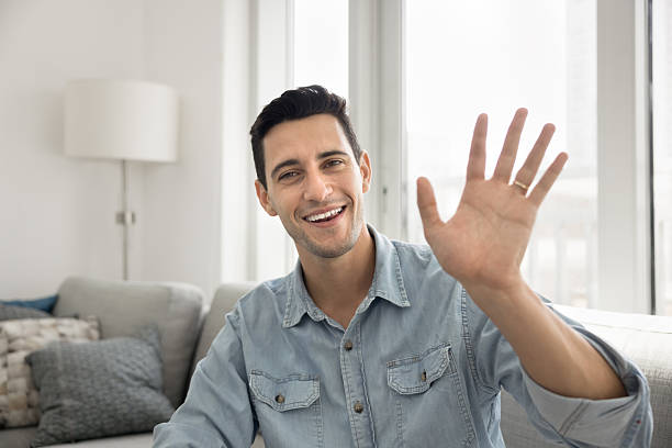 istock Cheerful handsome Latin man talking on video conference chat 2208545099