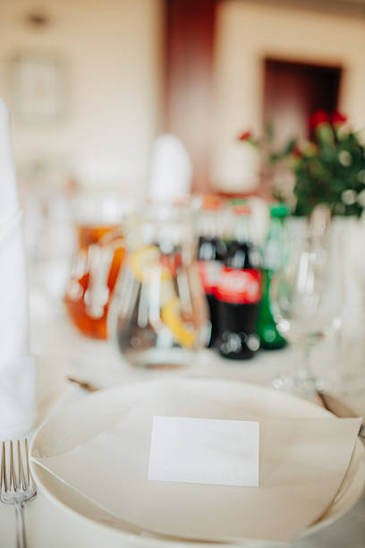 Close-up shot of a beautifully set birthday party table with a white tablecloth, creating an elegant and festive atmosphere for a special celebration
