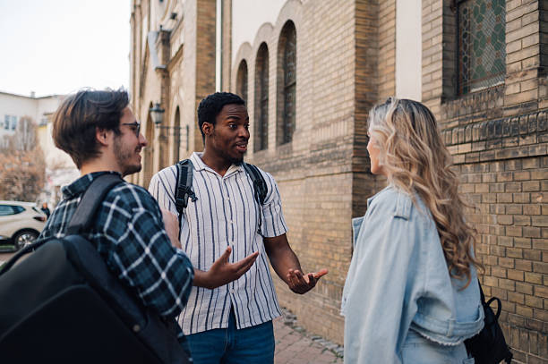 istock Students meeting and talking on city street 2208546089