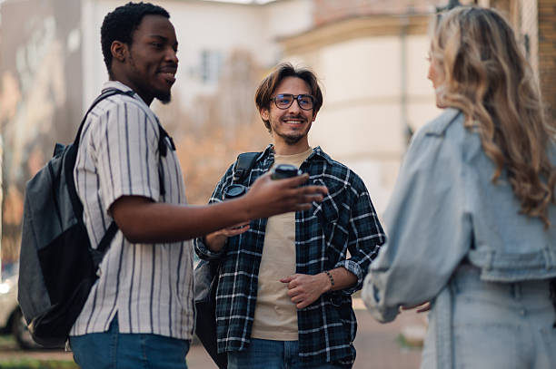 istock University students talking and drinking coffee outdoors 2208546140