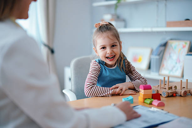 istock Smiling Child at a Pediatrician Appointment in a Friendly Doctor's Office 2208547175