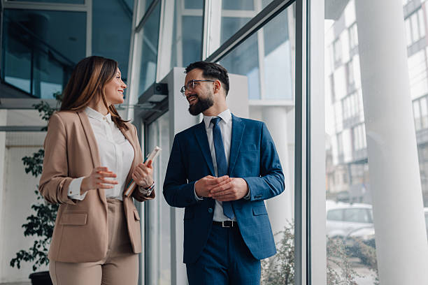istock Businesspeople walking and talking in modern office building 2208547886