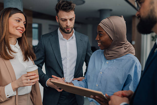 istock Business people discussing work in office hallway 2208547906