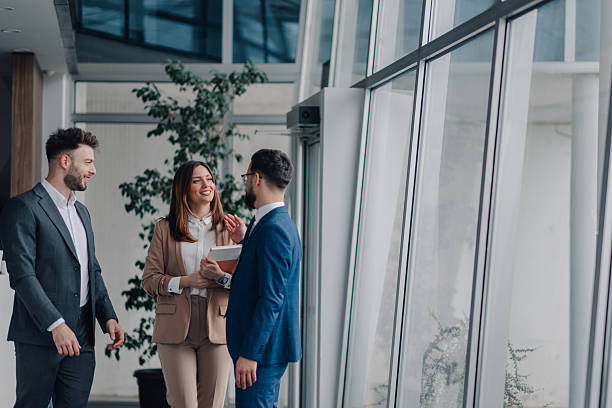 istock Businesspeople discussing work in modern office hallway 2208547908