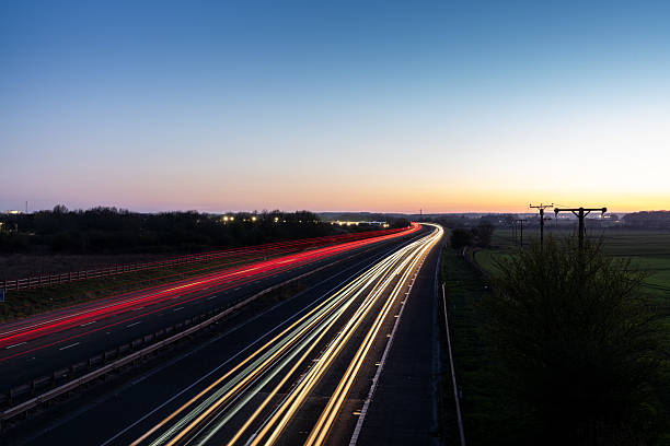 istock Light trails illuminating highway at dusk in United Kingdom 2208550515