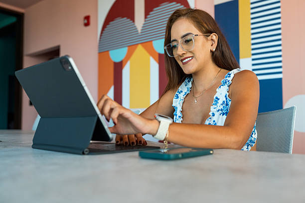 Woman working in her house with a computer on sony day