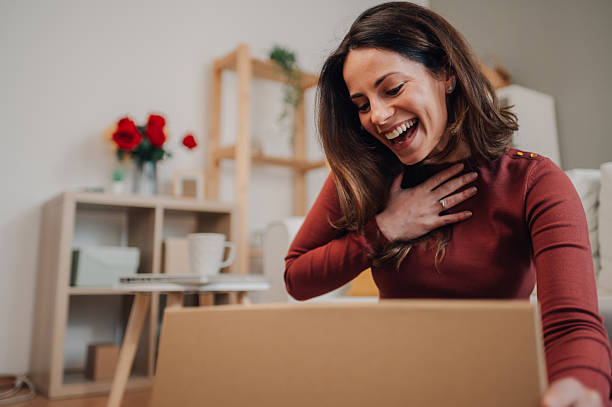 istock Excited woman opening a surprise gift box at home 2208551203