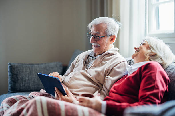 istock Senior Couple Relaxing at Home Using a Tablet Device, Smiling and Comfortable 2208551278