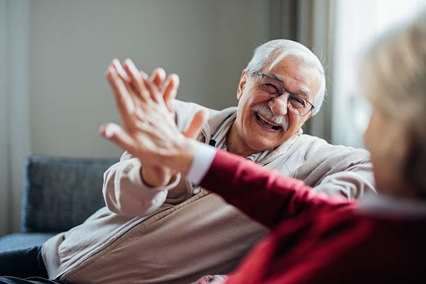 istock Senior Couple Sharing a Joyful High Five at Home 2208551297