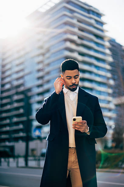 istock Modern Professional Checking Smartphone while Walking in Urban Area 2208552078