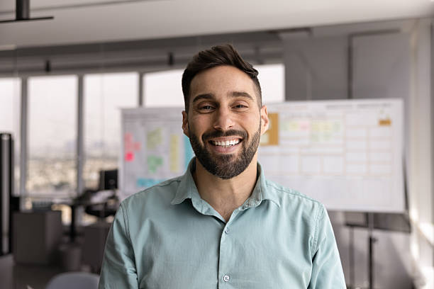 istock Happy handsome young Hispanic business man posing for head shot 2208552150