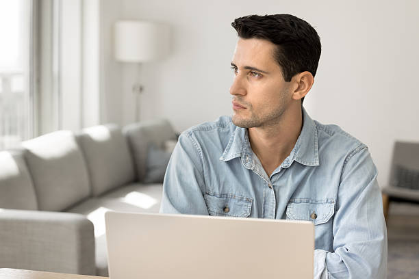 istock Serious pensive young Latin freelance entrepreneur man working at laptop 2208552463