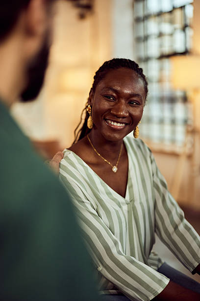 istock Smiling Woman Interacting in a Casual Setting With Warm and Cozy Lighting 2208552796