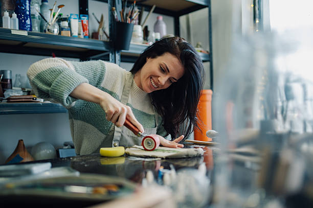 istock Female ceramist rolling clay in her workshop 2208552901