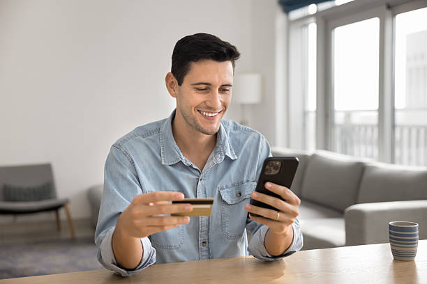 istock Positive joyful young Hispanic customer man enjoying financial Internet technology 2208553114