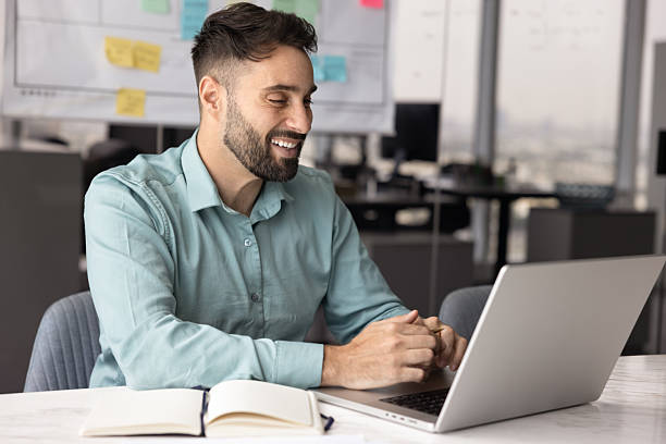 istock Positive Hispanic business professional man using laptop for job communication 2208554179