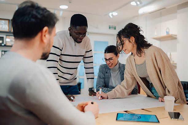 istock Diverse team of young professionals collaborating on a project in a modern office 2208554347