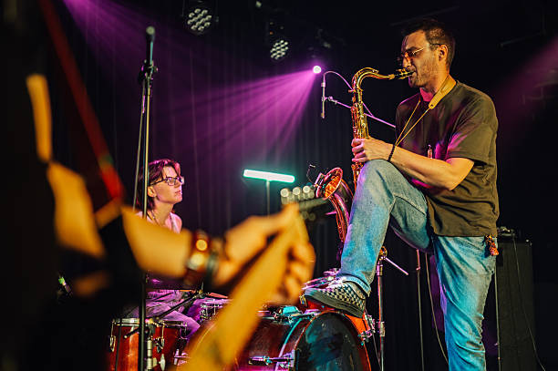 istock Saxophonist performing with band on stage 2208556376