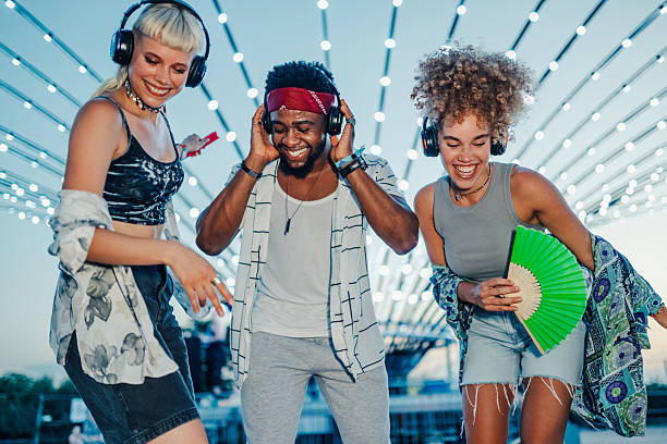 istock Young people enjoying silent disco at night 2208556958