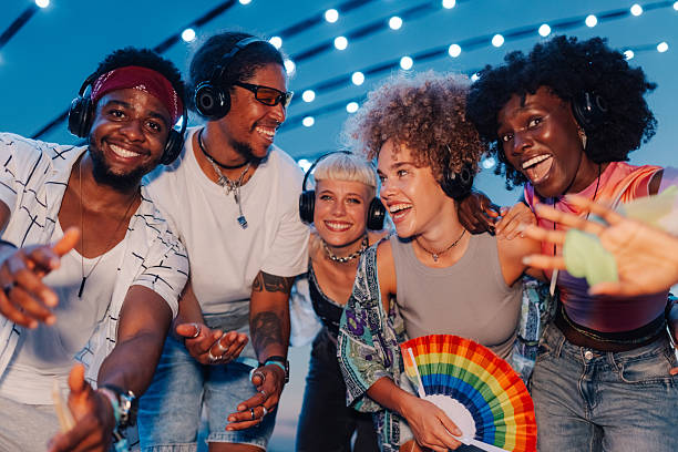 istock Group of diverse friends enjoying silent disco at pride event 2208556988