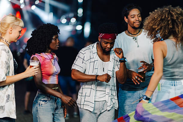 istock Young people dancing and drinking at music festival 2208557009
