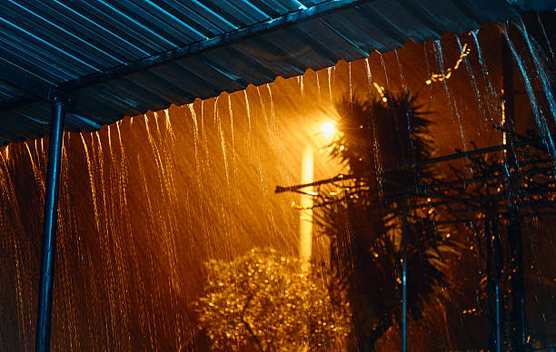 heavy rain on the street at night - yağmur firtina stok fotoğraflar ve resimler