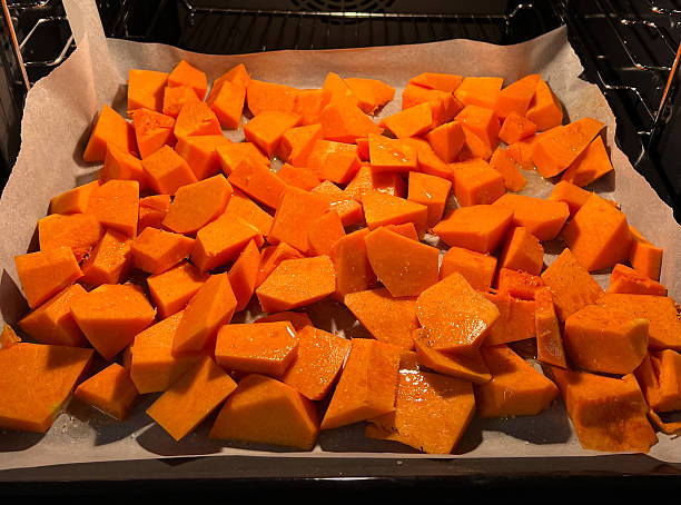 istock Roasted Butternut Squash Cubes Arranged Neatly on a Baking Sheet Ready for Cooking 2208557926