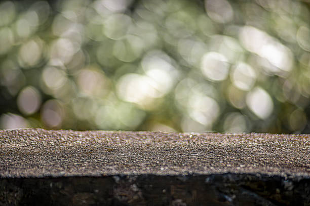 Empty top of natural stone table and sunny abstract blurred bokeh background