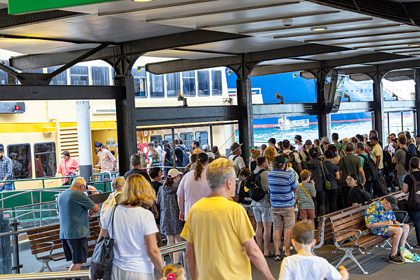 Sydney, Australia - March23, 2025: Ferry arrival at Circular Quay ferry wharf with passengers boarding fthe ferryCircular Quay ferry wharf is a complex of wharves at Circular Quay, on Sydney Cove, that serves as the hub for the Sydney Harbour ferry network.