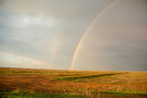 istock Evening sunset rainbow over the field. 2208572787