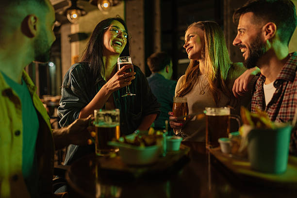 istock Friends drinking beer and laughing together in a Pub 2208573230