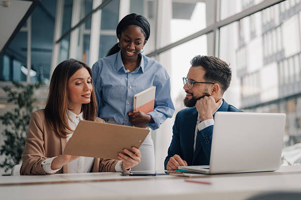 istock Business team analyzing documents and discussing strategies in modern office 2208573275