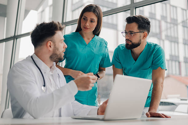 istock Medical team analyzing patient data on laptop in hospital 2208573305