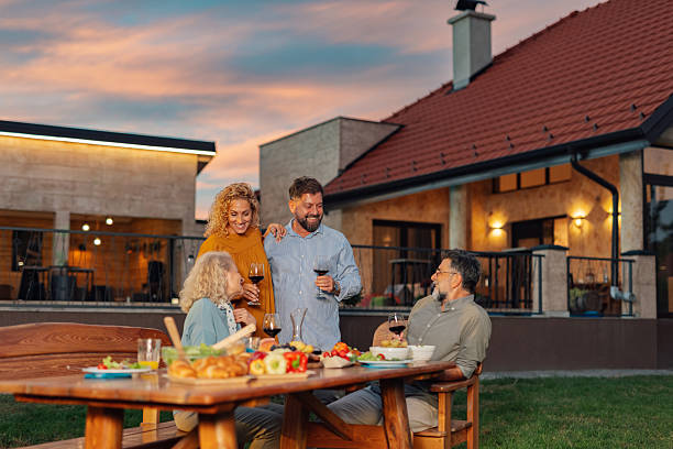 istock Happy family having dinner together in their backyard 2208573711